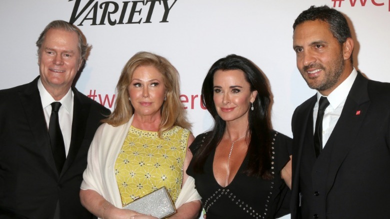 Rick and Kathy Hilton posing with Kyle Richards and Mauricio Umansky