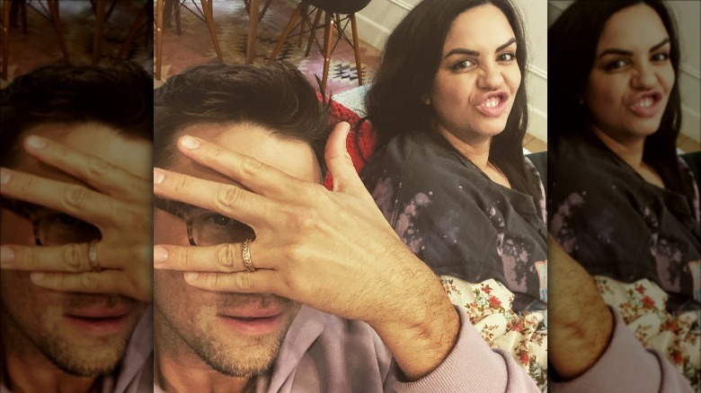 Tom Schwartz hides his face while Katie Maloney makes a goofy face in selfie