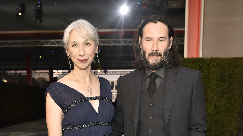 Keanu Reeves poses with his girlfriend
