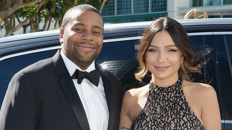 Kenan Thompson and Christina Evangeline smiling in front of a car