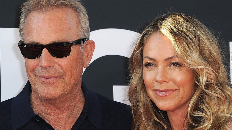 Kevin Costner and Christine Baumgartner smiling