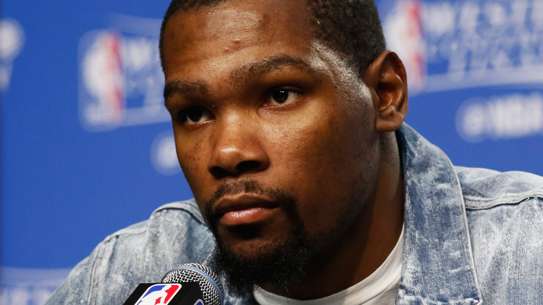 Kevin Durant wearing a jean jacket in a press conference