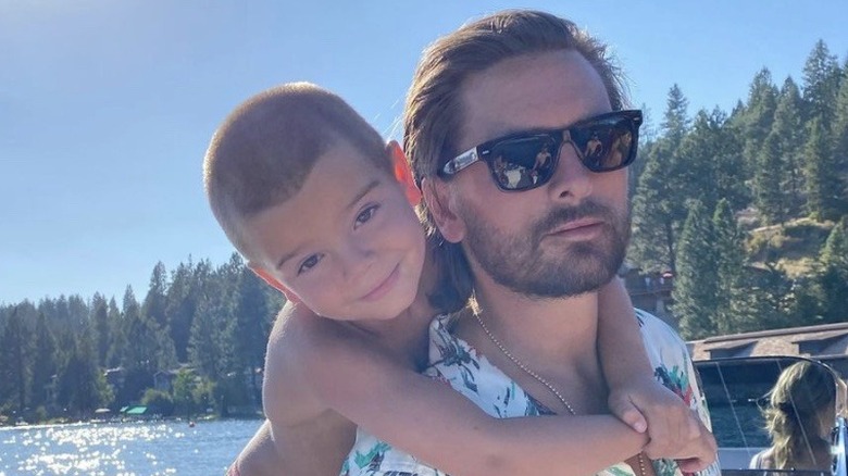 Reign Disick hugging Scott Disick on a boat