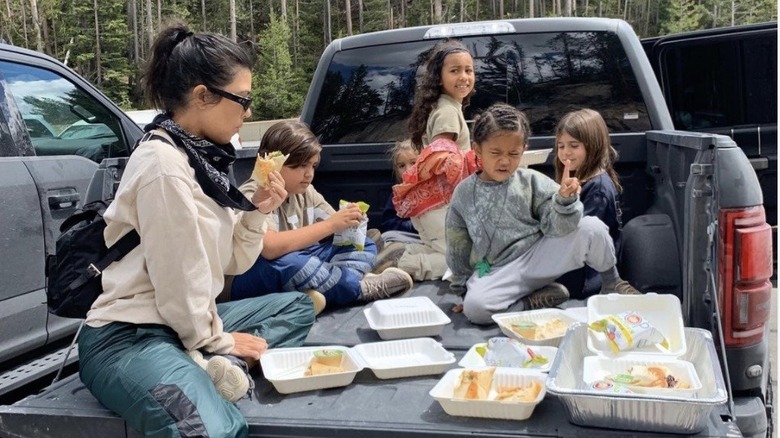 Kourtney Kardashian eating in a truck with her kids