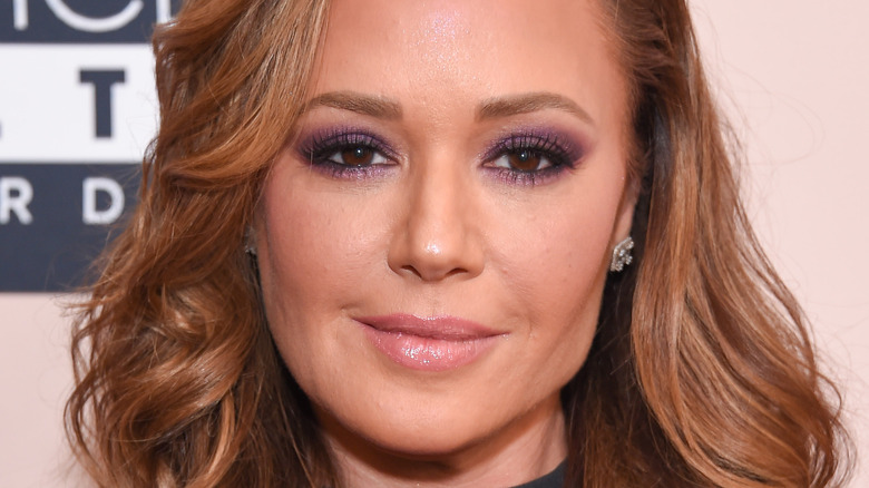 Leah Remini smiles on the red carpet