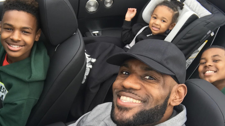 LeBron James and children in car