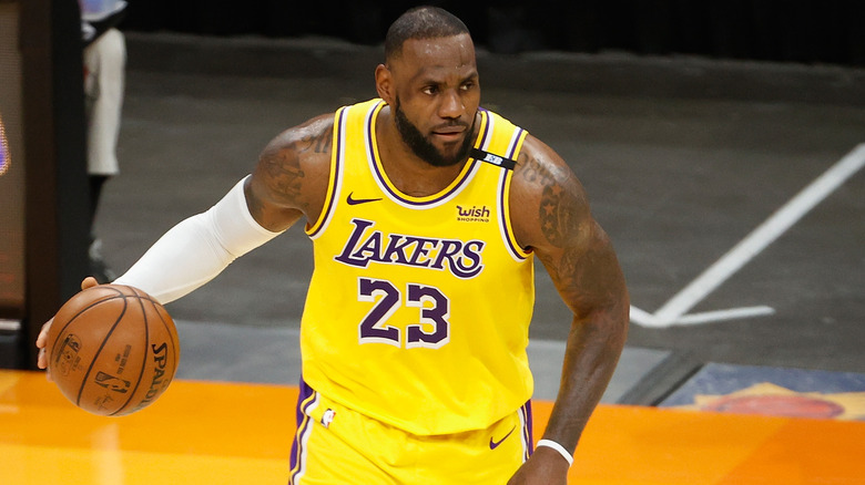 LeBron James #23 of the Los Angeles Lakers handles the ball in Game Five of the Western Conference first-round playoff series at Phoenix Suns Arena