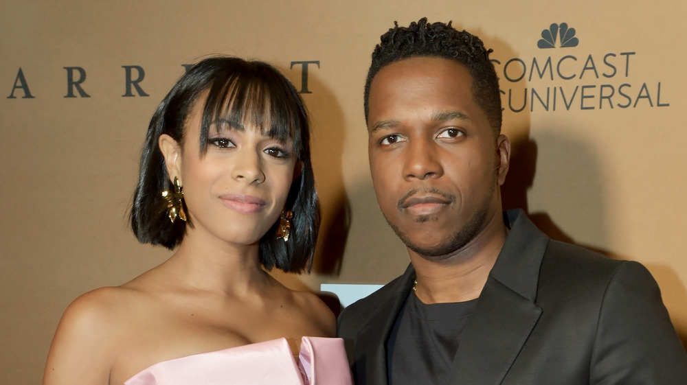 Nicolette Robinson and Leslie Odom Jr. posing at an event