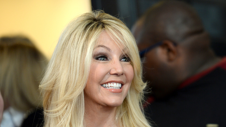 Heather Locklear looking to the side with wide smile