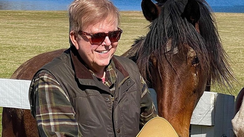 Lou Dobbs standing with horse