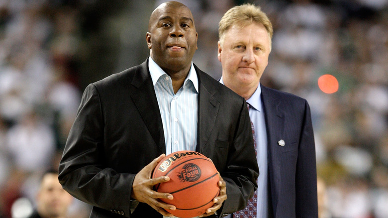 Larry Bird and Magic Johnson wearing suits