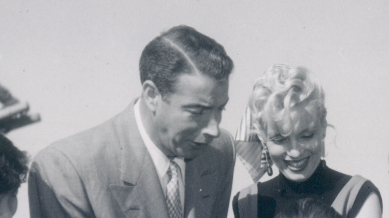 Marilyn Monroe and Joe DiMaggio smiling