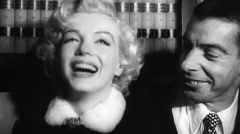 Marilyn Monroe and Joe DiMaggio smiling