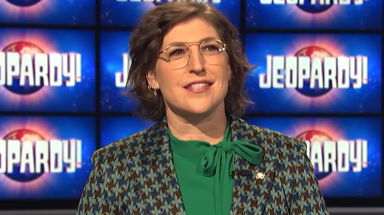 Mayim Bialik smiles on the set of Jeopardy!