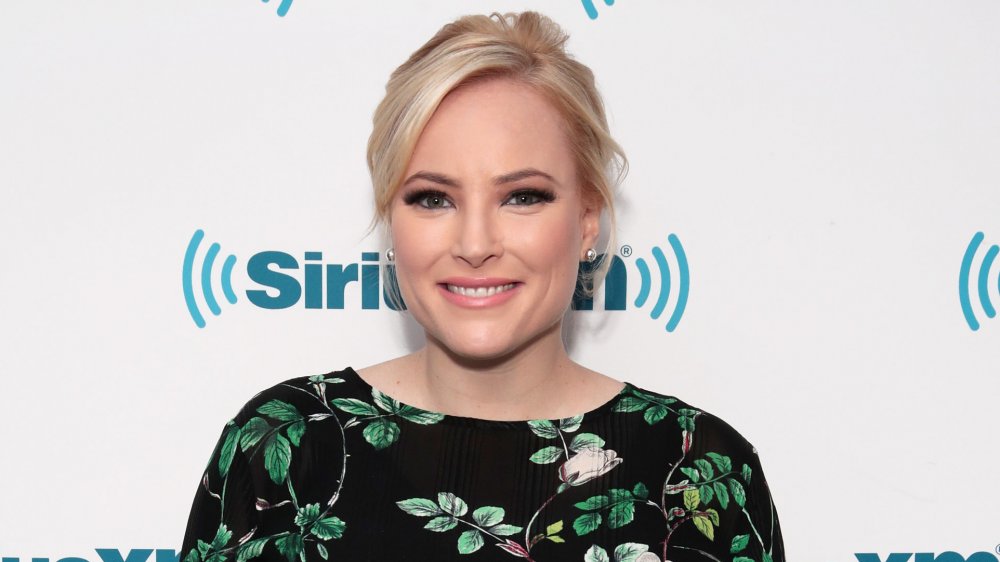 Meghan McCain in a black and floral top, smiling at a SiriusXM event