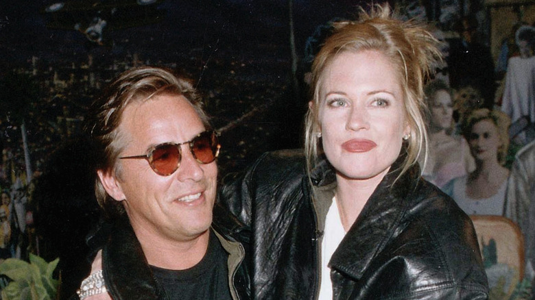 Melanie Griffith Don Johnson in leather jackets, posing