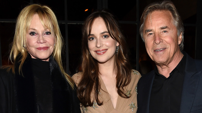 Melanie Griffith and Don Johnson posing with Dakota Johnson 