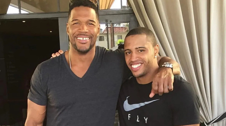 Michael Strahan and his son, arm in arm and smiling