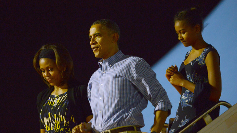 Michelle, Barack, and Sasha Obama leaving Air Force One