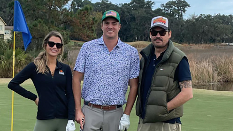 Naomie Olindo, Shep Rose, and Whitney Sudler-Smith playing golf