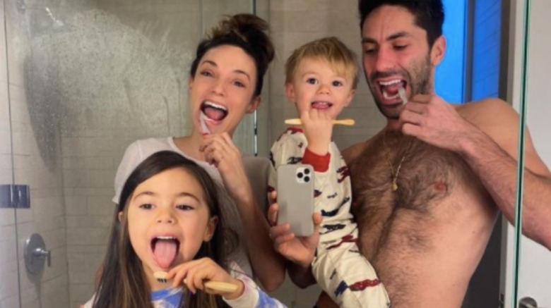Nev Schulman and Laura Perlongo taking a photo with their kids
