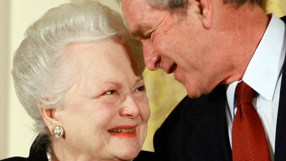 Olivia de Havilland, George W. Bush smiling and looking each other in the eye