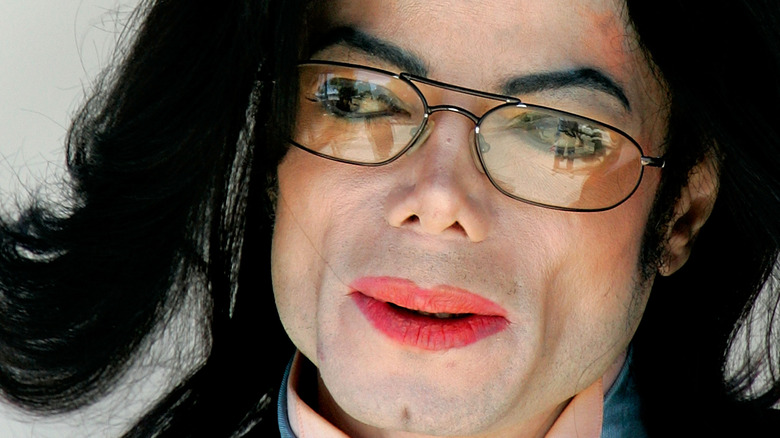 Michael Jackson wearing glasses and red lipstick