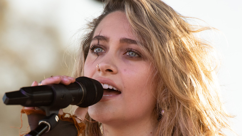 Paris Jackson singing into microphone