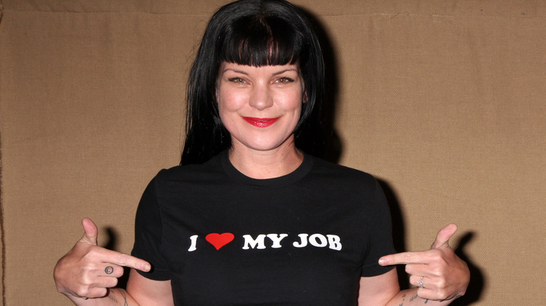 Pauley Perrette pointing to shirt