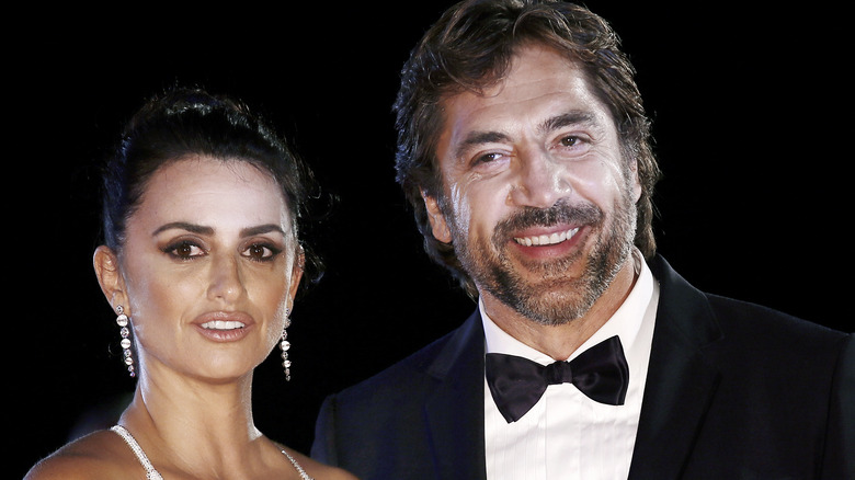 Penélope Cruz wearing diamond earrings, Javier Bardem wearing bowtie