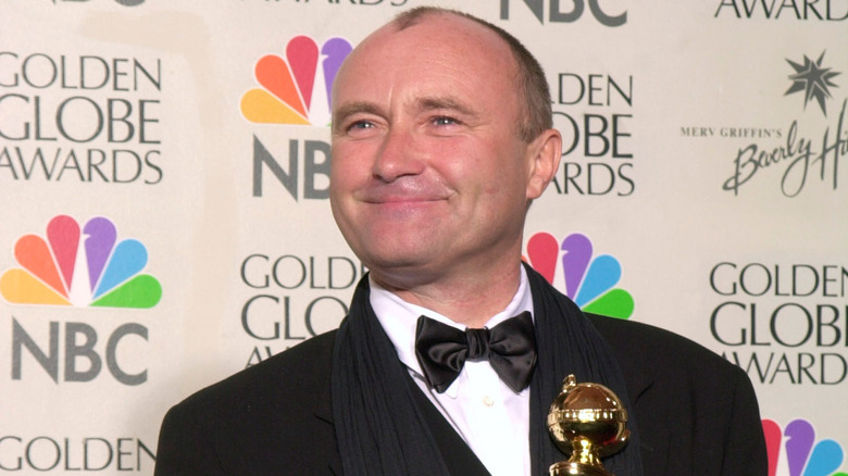 Phil Collins smiling with award