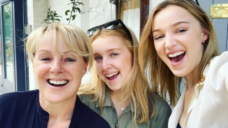 Phoebe Dynevor posing with mom and sister