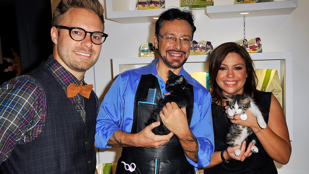 Jorge Bendersky holding a shelter cat at an event with Rachael Ray