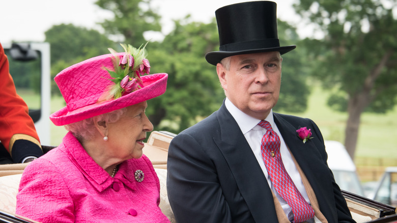 queen elizabeth and prince andrew dressed up in a car