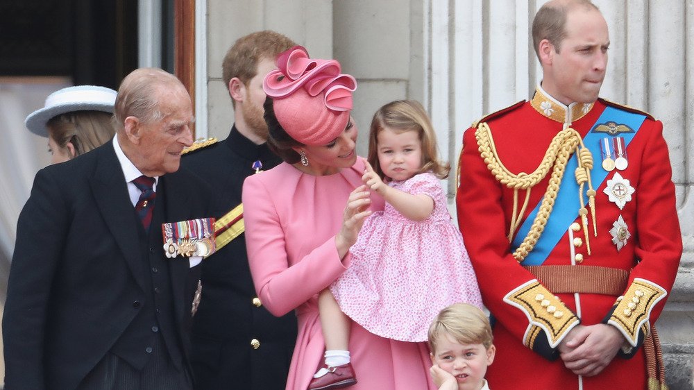 Prince Philip looking at baby Charlotte