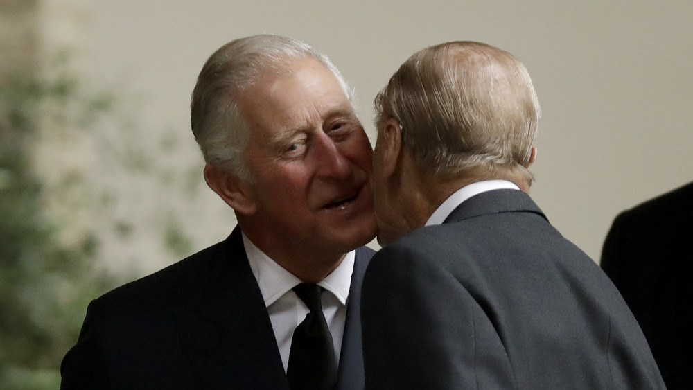 Prince Charles is warmly greeted by Prince Philip 