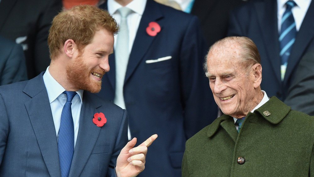 Prince Harry talking with Prince Philip 