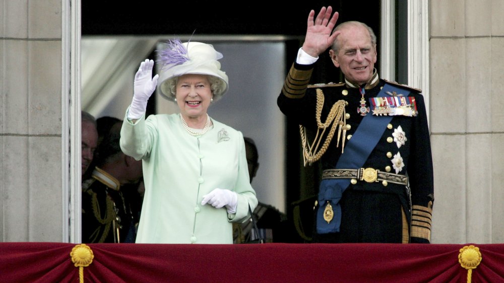 Prince Philip and Queen Elizabeth watch the flypast over The Mall of British and US World War II aircraft from the Buckingham Palace balcony on National Commemoration Day in 2005