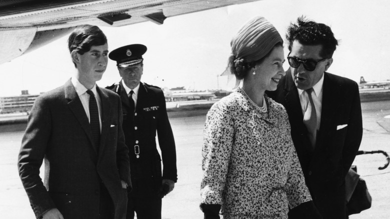 King Charles III and Queen Elizabeth II leaving an airplane