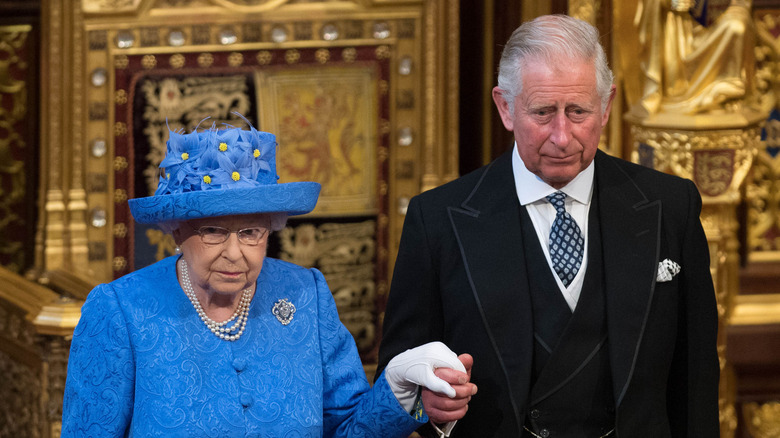 King Charles III and Queen Elizabeth II holding hands