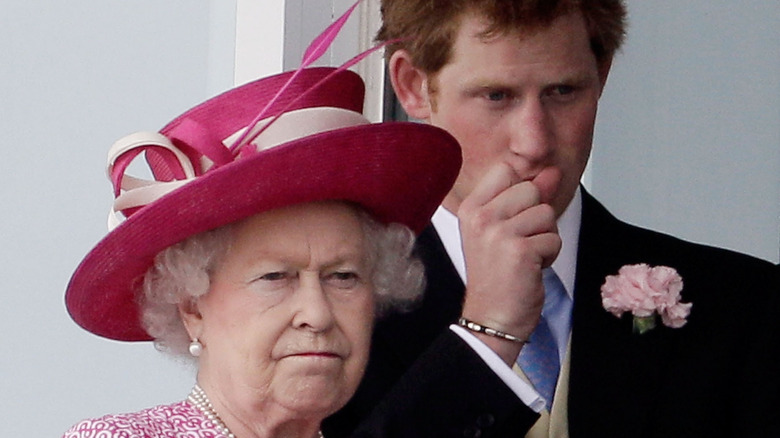 Queen Elizabeth and Prince Harry looking solemn 