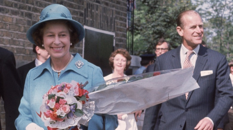 Queen Elizabeth smiles alongside Prince Philip