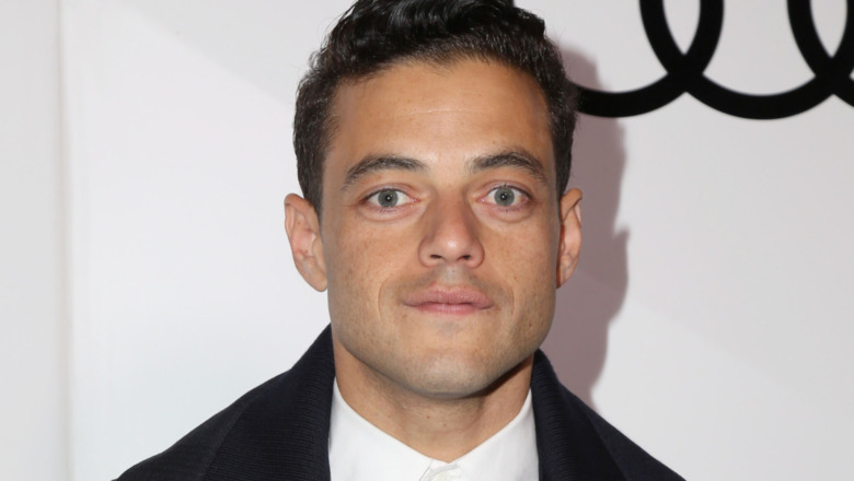 Rami Malek poses at an event