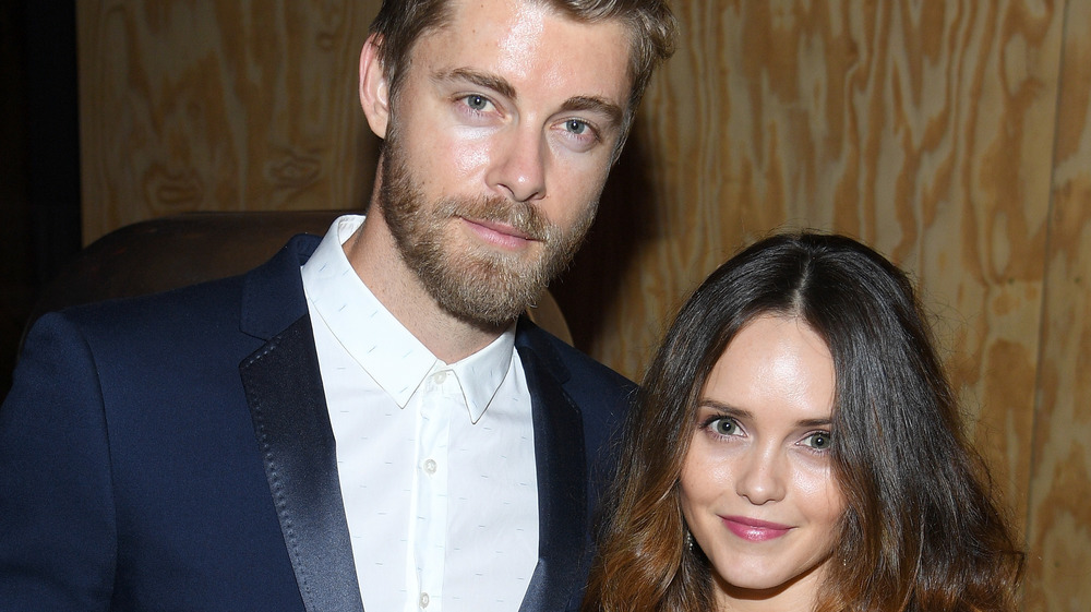 Luke Mitchell posing with Rebecca Breeds at a social event