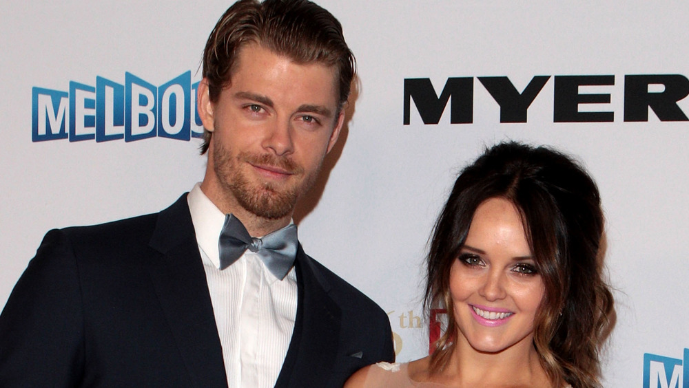 Luke Mitchell and Rebecca Breeds pose together at an event