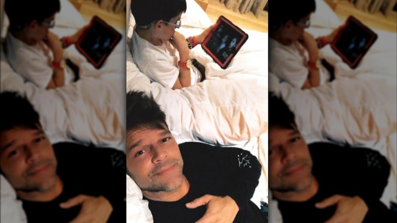 Ricky Martin taking selfie, Valentino watching notepad