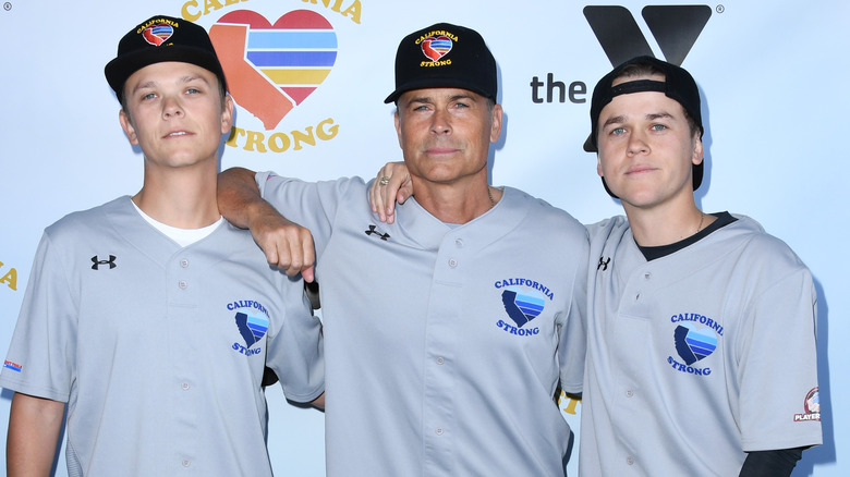 Matthew, Rob, and Johnny Lowe posing in baseball hats