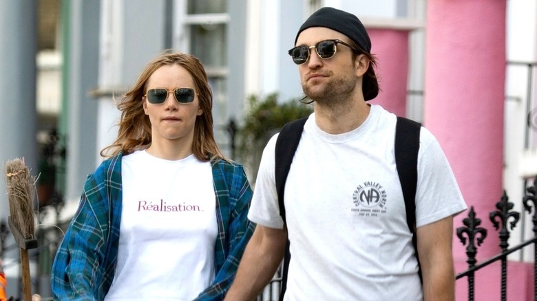 Robert Pattinson and Suki Waterhouse walk on street