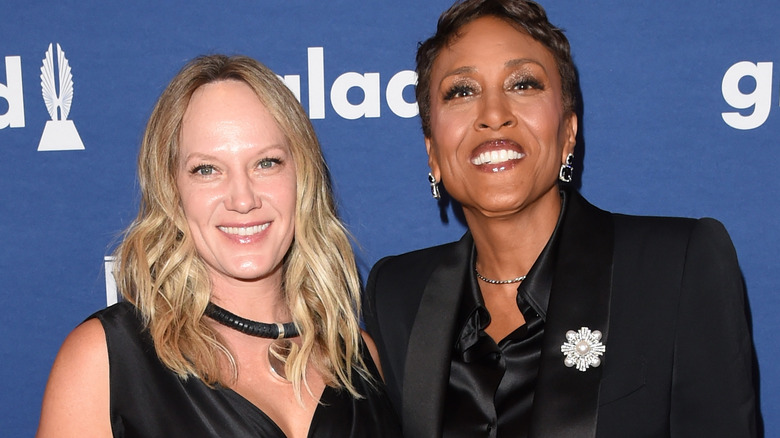 Robin Roberts and longtime girlfriend Amber Laign posing