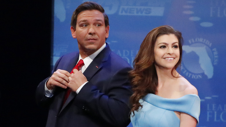 Ron DeSantis poses alongside wife Casey DeSantis at a convention